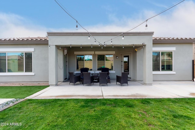 rear view of property with a yard and a patio area