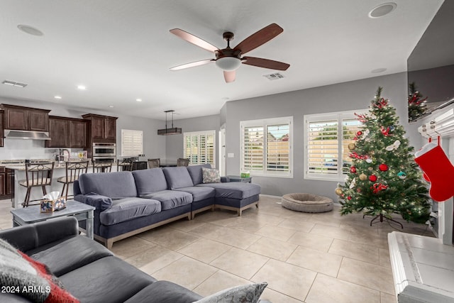 living room with ceiling fan and light tile patterned floors