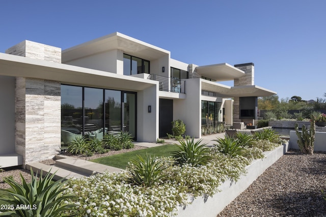 4451 E Joshua Tree Ln, Paradise Valley, AZ 85253 - back of house with a balcony, stucco siding, and stone siding