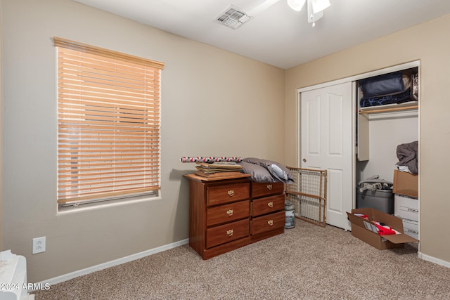 carpeted bedroom with ceiling fan and a closet