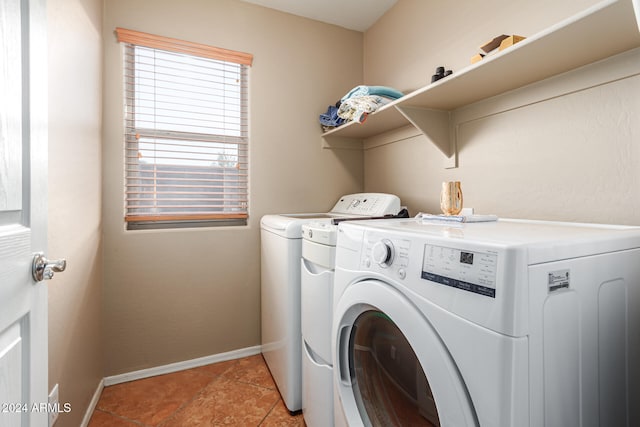 washroom with washing machine and clothes dryer