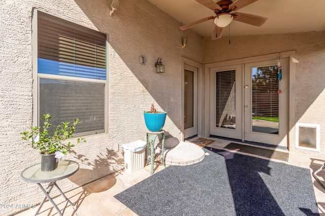 doorway to property featuring ceiling fan and a patio area