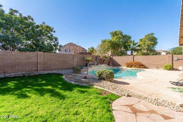 view of swimming pool with a lawn and a patio