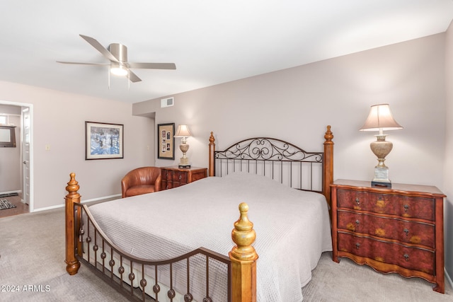 bedroom with ensuite bath, ceiling fan, and light carpet