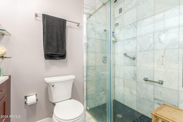 bathroom with vanity, toilet, and a shower with door