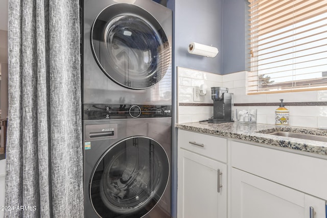 laundry area with stacked washing maching and dryer