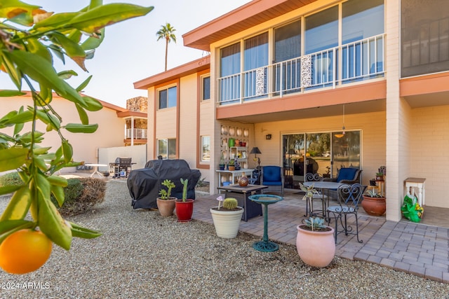 rear view of house featuring a balcony and a patio area