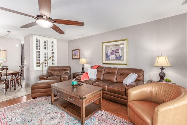 living room with light wood-type flooring and ceiling fan