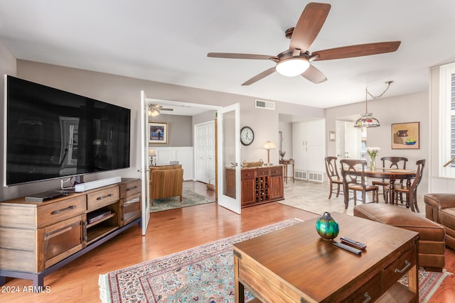 living room with ceiling fan and light wood-type flooring