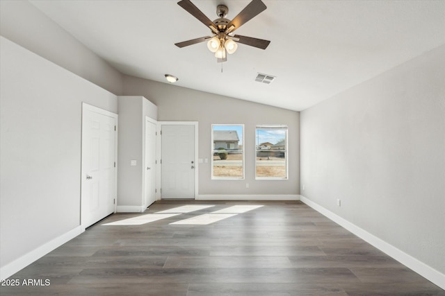 unfurnished bedroom with vaulted ceiling, wood finished floors, visible vents, and baseboards