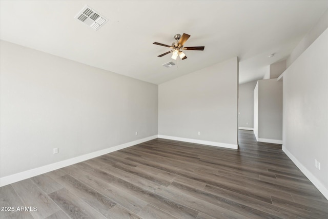 spare room with baseboards, ceiling fan, visible vents, and dark wood-style flooring