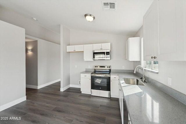 kitchen with visible vents, white cabinets, lofted ceiling, appliances with stainless steel finishes, and a sink