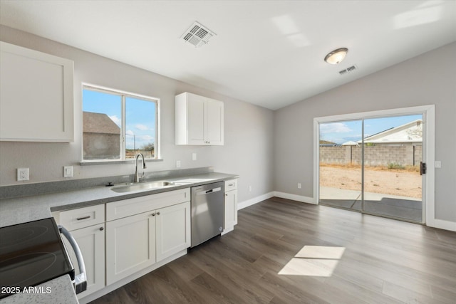 kitchen featuring visible vents, dishwasher, vaulted ceiling, white cabinetry, and a sink