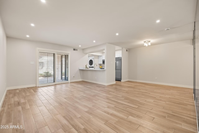 unfurnished living room with light wood-type flooring