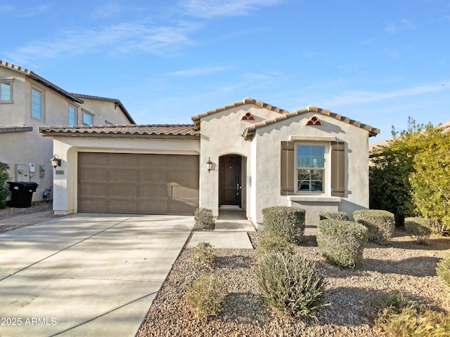 mediterranean / spanish-style home with a garage