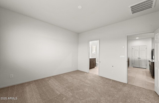 5053 S 252nd Ave, Buckeye, AZ 85326 - spare room with light tile patterned flooring, visible vents, and light colored carpet