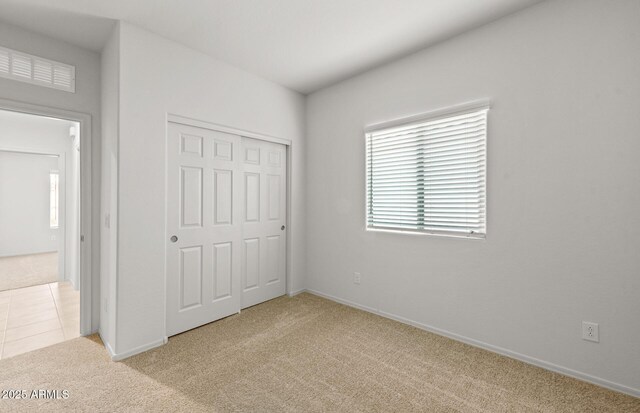 5053 S 252nd Ave, Buckeye, AZ 85326 - unfurnished bedroom with baseboards, a closet, and light colored carpet