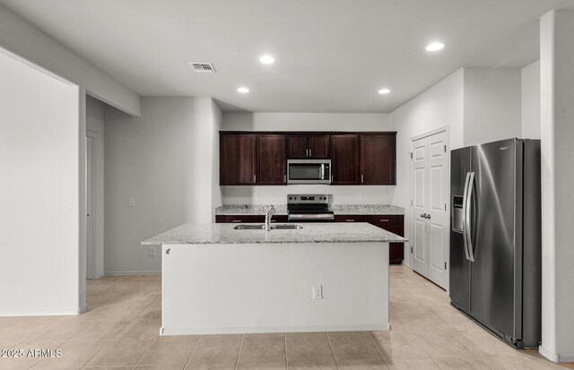 5053 S 252nd Ave, Buckeye, AZ 85326 - kitchen featuring dark brown cabinetry, a sink, light stone countertops, appliances with stainless steel finishes, and visible vents