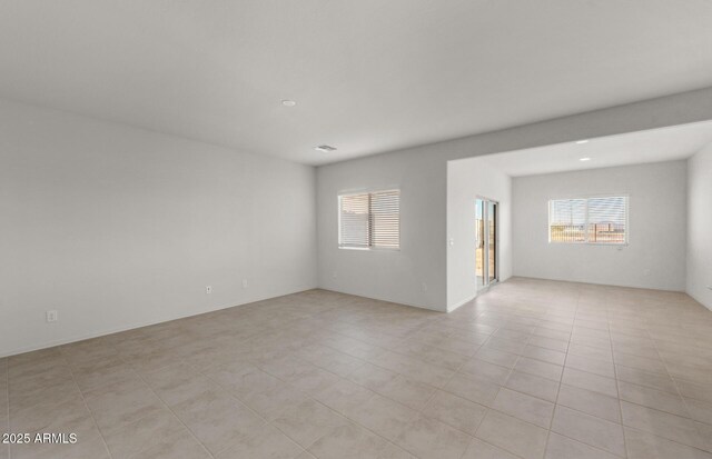 5053 S 252nd Ave, Buckeye, AZ 85326 - empty room featuring visible vents and a healthy amount of sunlight