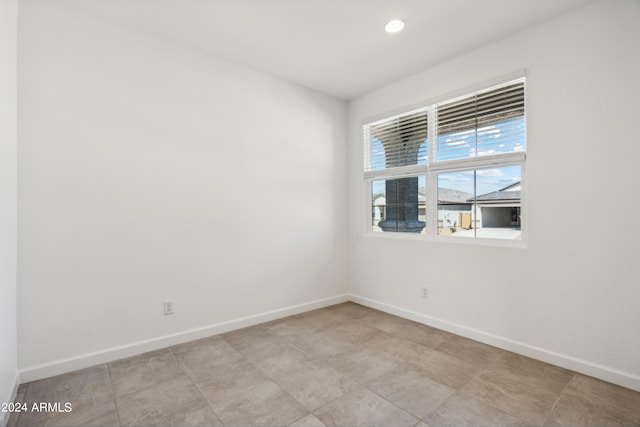 unfurnished room with recessed lighting and baseboards