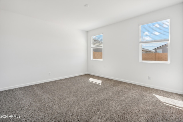 empty room with carpet and baseboards