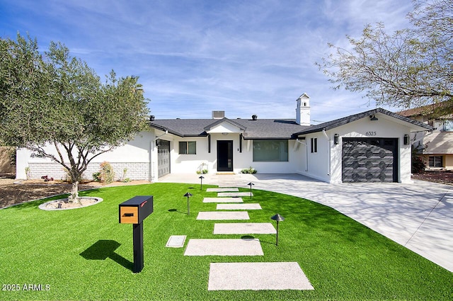 view of front facade with a front yard, driveway, an attached garage, and stucco siding