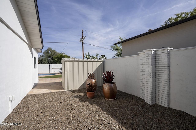 6325 N 83rd Pl, Scottsdale, AZ 85250 - view of yard with an outdoor structure, fence, a fenced in pool, and a storage unit