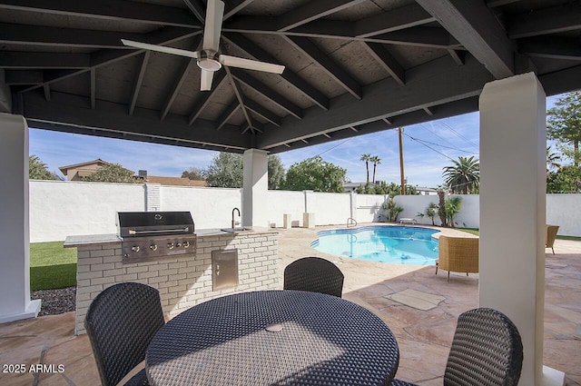 6325 N 83rd Pl, Scottsdale, AZ 85250 - view of swimming pool with area for grilling, exterior kitchen, a sink, a fenced backyard, and a patio