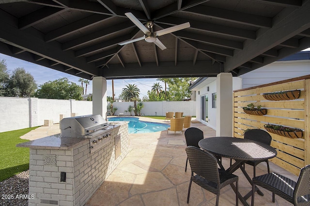 6325 N 83rd Pl, Scottsdale, AZ 85250 - view of patio featuring grilling area, a fenced backyard, an outdoor kitchen, a fenced in pool, and a ceiling fan