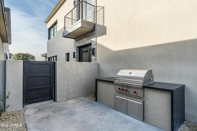 view of patio featuring a balcony, area for grilling, and grilling area