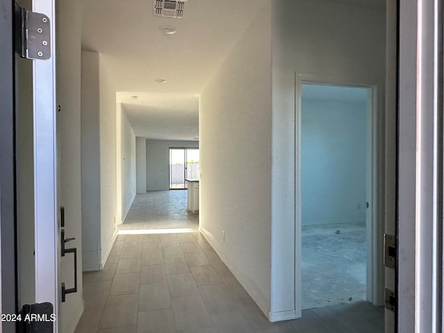 corridor with tile flooring