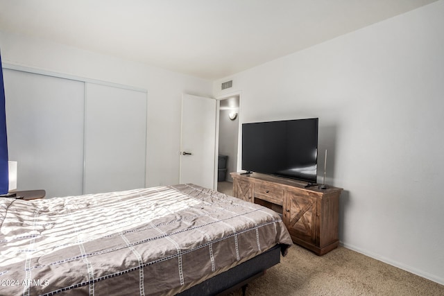 carpeted bedroom with a closet