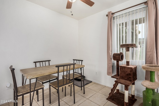 dining space featuring light tile patterned floors and ceiling fan