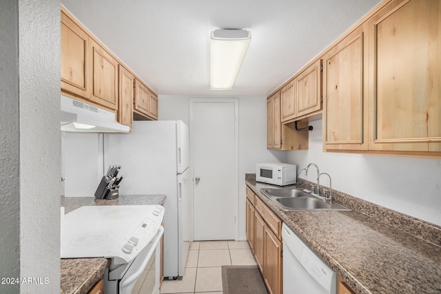 kitchen with light tile patterned floors, white appliances, light brown cabinets, and sink