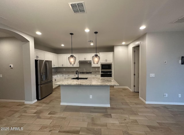 kitchen with a sink, visible vents, white cabinets, and stainless steel appliances