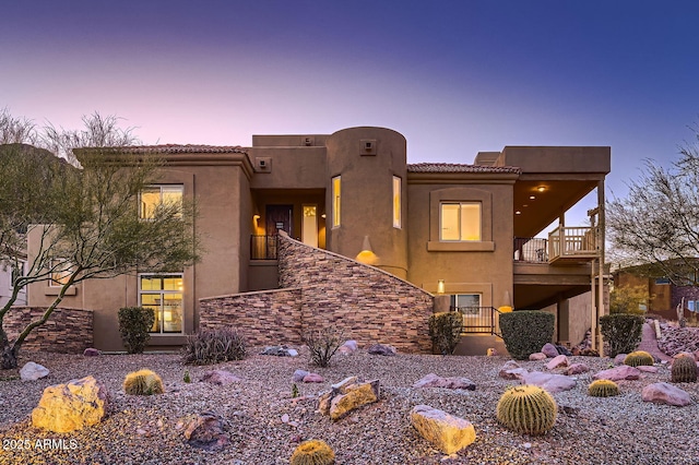 pueblo-style house with a balcony