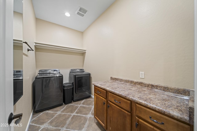 washroom with washing machine and clothes dryer and light tile patterned floors