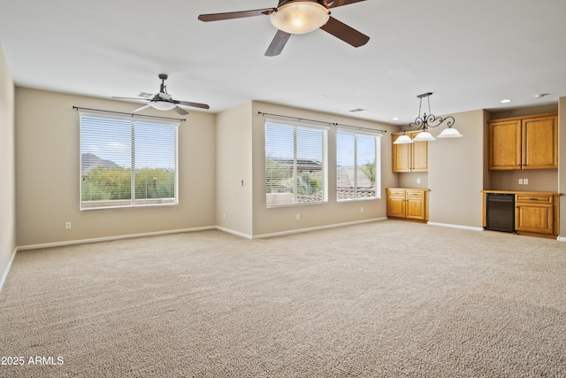 unfurnished living room with light colored carpet and ceiling fan