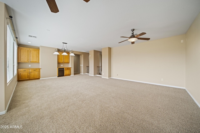 unfurnished living room with light carpet and ceiling fan