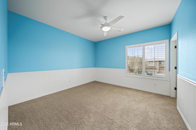 empty room featuring ceiling fan and carpet floors