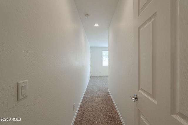 hall with carpet, baseboards, and recessed lighting