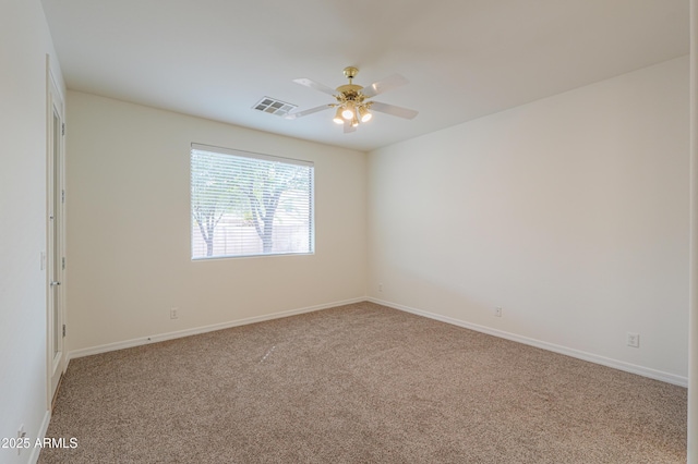 unfurnished room featuring carpet floors, visible vents, ceiling fan, and baseboards