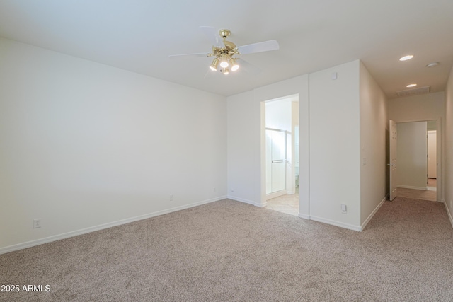 empty room featuring a ceiling fan, recessed lighting, light colored carpet, and baseboards