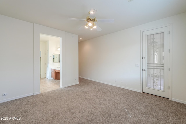 unfurnished room with light colored carpet, ceiling fan, and baseboards