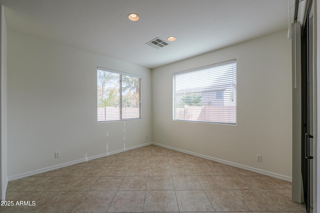 unfurnished room featuring recessed lighting, light tile patterned flooring, visible vents, and baseboards