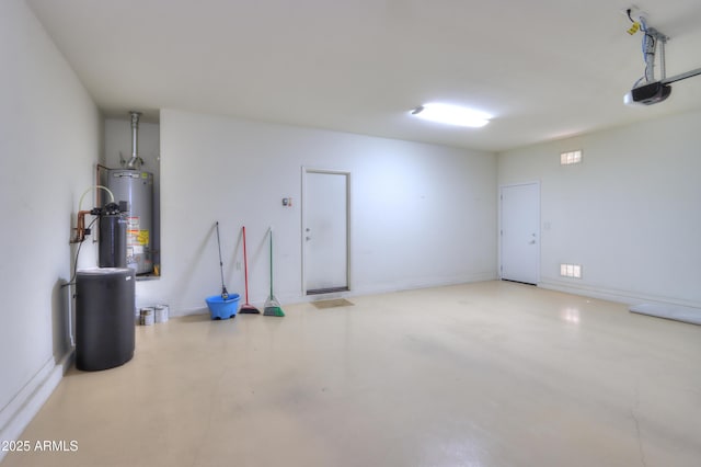 garage with baseboards, gas water heater, and a garage door opener