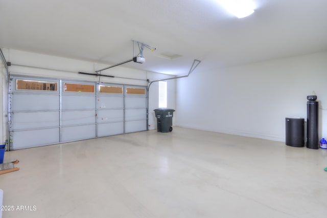 garage with a garage door opener and baseboards