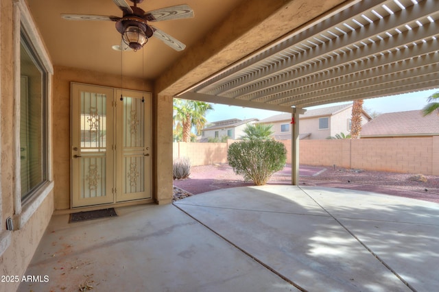 view of patio featuring ceiling fan and fence