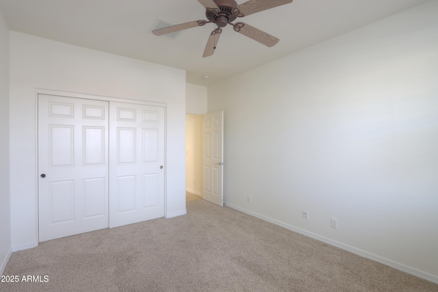 unfurnished bedroom with carpet floors, a closet, baseboards, and a ceiling fan