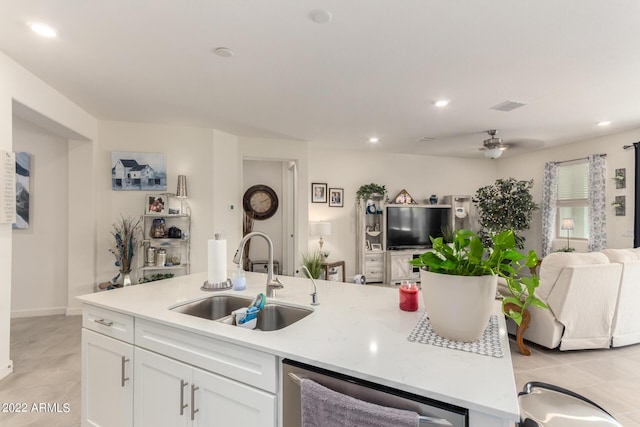 kitchen with ceiling fan, dishwasher, sink, light tile patterned floors, and white cabinets